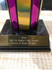 Closeup of the Krewe of Kazoo trophy presented to the LunaChicks following the 2024 St Patrick's Day parade